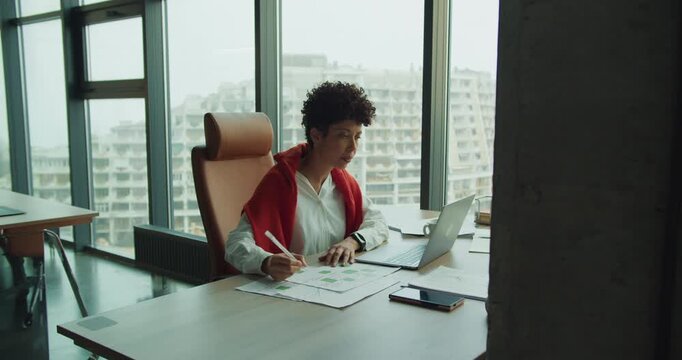 Business expert studying infrastructure projects with skyline backdrop