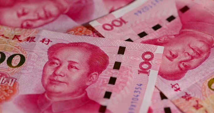 Chinese money with a face value of 100 yuan, Chinese cash in red with national symbols of China, close up