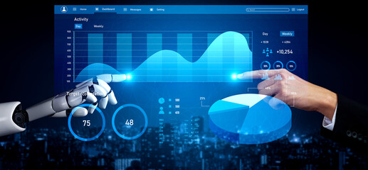 A high-tech scene featuring a human hand and a robot hand interacting with a digital interface displaying data analytics and graphs. Impute
