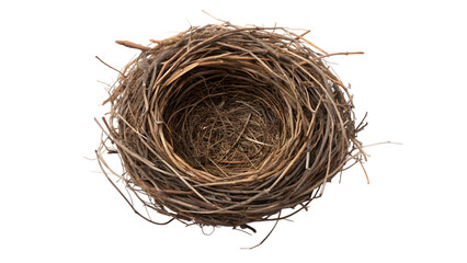 An empty brown bird nest made of natural straw and twigs isolated on a white background