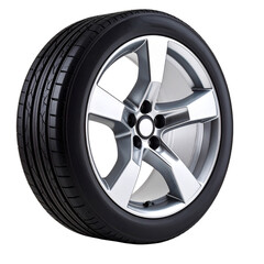 Obraz premium Car tire with silver alloy rim on white background