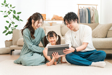 Family watching tablet with girl at home, Family