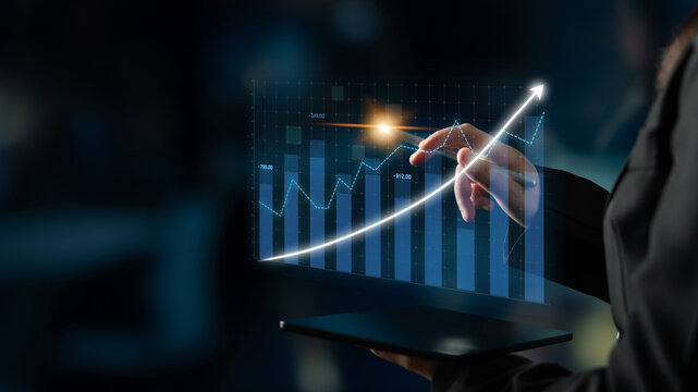 A businesswoman interacts with a digital tablet displaying innovative graph visualizations, highlighting financial data and growth trends in a modern office setting. Impute - Powered by Adobe