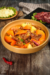Chinese Beef Stew with Potatoes and Carrots in Clay Bowl