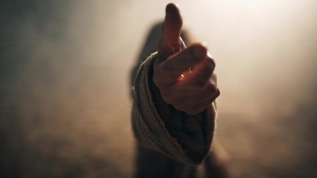 A close-up shot of a person's outstretched open hand in a gesture of help or offering.