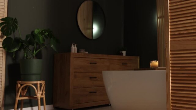 Tub, wooden folding screen and vanity in bathroom, camera moving right. Interior design