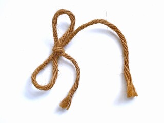 jute rope tied into a bow. Jute rope is a natural, plant-based fiber.