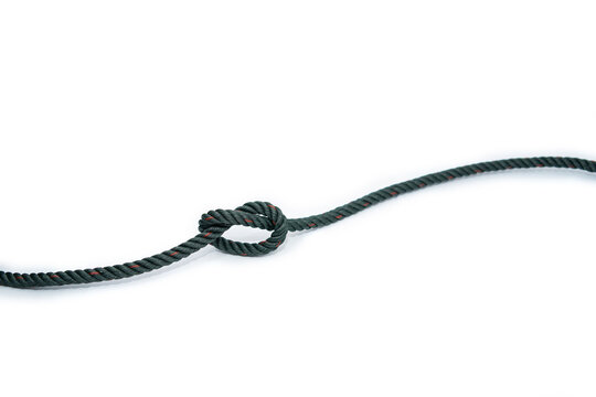 A single dark green twisted rope with red tracer highlights, tied into a simple overhand knot, positioned horizontally against a minimalist white background