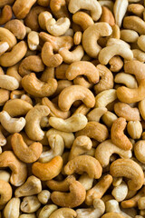 Fototapeta premium Roasted and raw luxury cashews background,This image can be used horizontally or vertically.