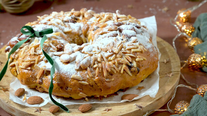 Festive Almond Christmas Cake with Powdered Sugar and Golden Lights