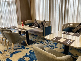 modern luxury restaurant interior with elegant furniture and blue patterned carpet