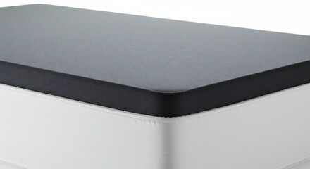 Bright studio light beautifully illuminates a contemporary minimalist block featuring a dark matte top and clean white sides. AI Generated