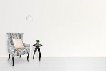 Modern contemporary style living room The interior is decorated with a gray cloth armchair with a checkered pattern, a black side table, a plant pot, a ceiling lamp, an empty white wall on the right.