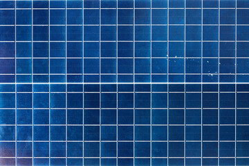 Close-up of blue solar panels capturing solar energy with rectangular grid pattern