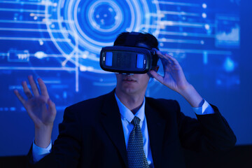 Man wearing virtual reality headset engages with digital interface in a modern setting during a technology presentation