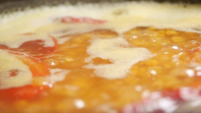 Cooking soup with vegetables and broth in a pot