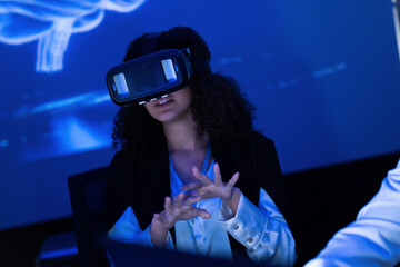 Woman experiencing virtual reality in a tech lab during a demonstration session on innovative technologies