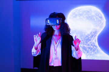 Woman interacting with virtual reality technology in a modern setting during a tech event