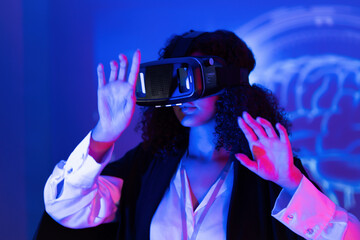 Woman wearing virtual reality headset in modern technology setting exploring immersive experiences