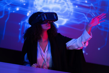 Young woman explores virtual reality technology in an interactive learning environment during evening hours