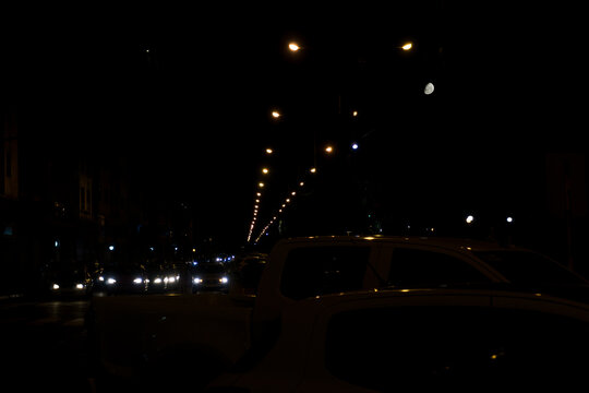 Night urban scene in low key, with the moon aside
