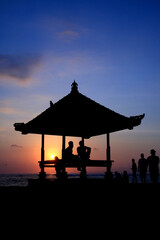 Serene Bali Sunrise: Silhouette of a Traditional Gazebo at Sanur Beach