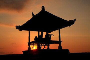 Serene Bali Sunrise: Silhouette of a Traditional Gazebo at Sanur Beach
