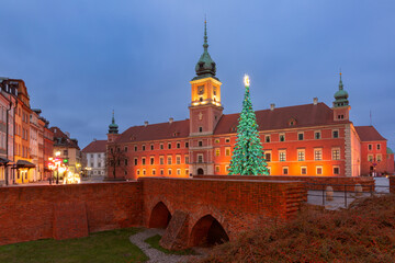 Illuminated Christmas decorations and tree at main square in Warsaw, Poland during winter evening