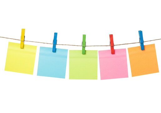 Colorful sticky notes clipped with bright pegs on string isolated on white background, creative planning and reminder concept for productivity, education, and idea organization.
