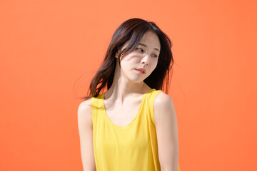 オレンジ背景　女性　ポートレート