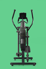 Naklejka premium Elliptical machine on green background