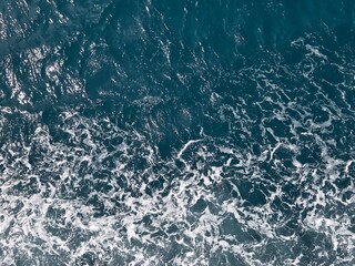 Fototapeta premium blue ocean with light waves of white foam