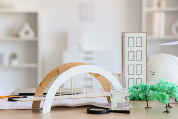 Architect's supplies with 3D models on table in office, closeup