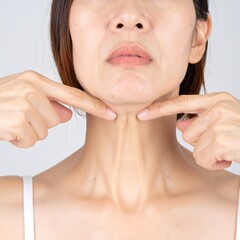 Woman examining neck wrinkles