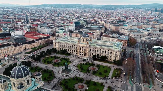 Aerial drone shot of the Austrian National History Museum in Vienna, showing the grand historic fa&ccedil;ade with surrounding city streets and rooftops, framed by the Vienna cityscape under clear winter