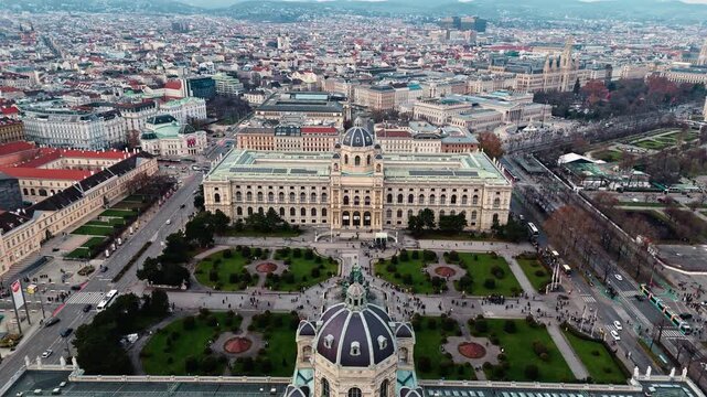 Aerial static drone shot of the Austrian Natural History Museum in Vienna, showcasing the grand historic fa&ccedil;ade with surrounding winter cityscape, streets, and rooftops under clear daylight.