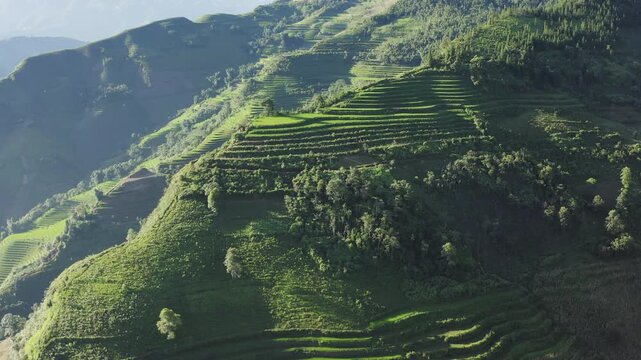 Cinematic tracking footage of the northern Vietnamese mountains. Featuring vibrant green rice terraces, remote valley ridges, and misty peaks captured during a scenic motorbike scouting trip.