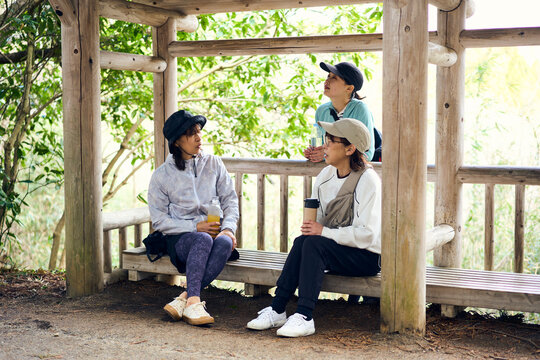 自然の中で休憩しながら会話を楽しむ女性達