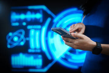 Woman using smartphone with smartwatch in futuristic blue digital interface background, representing smart technology, connectivity, innovation, data interaction, digital transformation.
