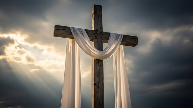 A poignant wooden cross draped with a white cloth stands against a dramatic sky with golden sun rays, symbolizing Easter, resurrection, and hope.