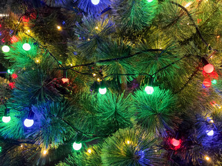 Clode up the Christmas tree with lights is decorated with colorful bulbs.