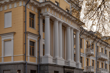 Classical yellow building facade with white columns © igor_zubkov