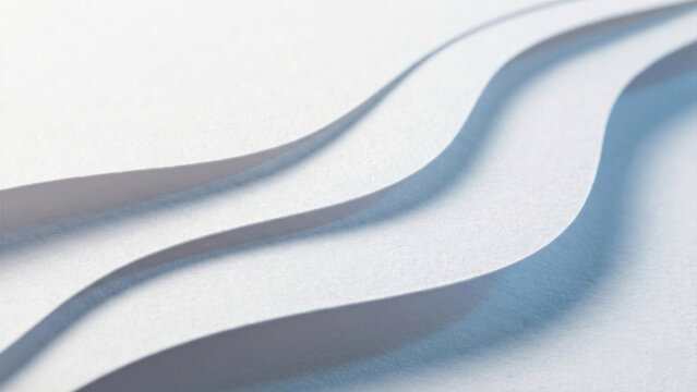 White layered paper waves abstract background with raking light and texture