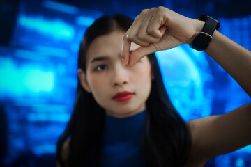 Futuristic woman interacting with virtual holographic interface, touching transparent digital screens in blue cyber environment, data controly, immersive human computer interaction.
