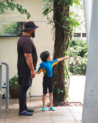 Little girl pointing on something to the father in the water park in Malaysia.