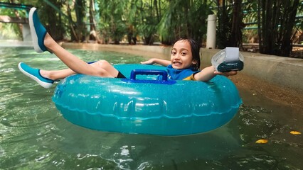 Little girl on the giant float in a water park in Malaysia.
