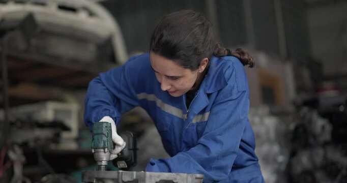 Auto mechanic disassemble mechanical engine components for diagnosis, troubleshooting in automotive workshop. Technical expertise, precision required in field of vehicle repair and maintenance.
