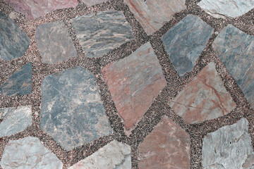 Decorative stone pavement with irregularly shaped natural rocks set in concrete.