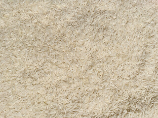 White jasmine rice grain texture background. Natural food texture with organic pattern.
