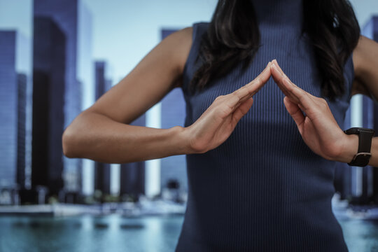 Businesswoman hand toward a modern city skyline, smart urban development, investment opportunity, corporate vision, real estate growth, future planning, innovative metropolitan business. - Powered by Adobe